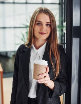 woman-in-formal-clothes-standing-indoors-in-the-of-RL3HSGC.jpg